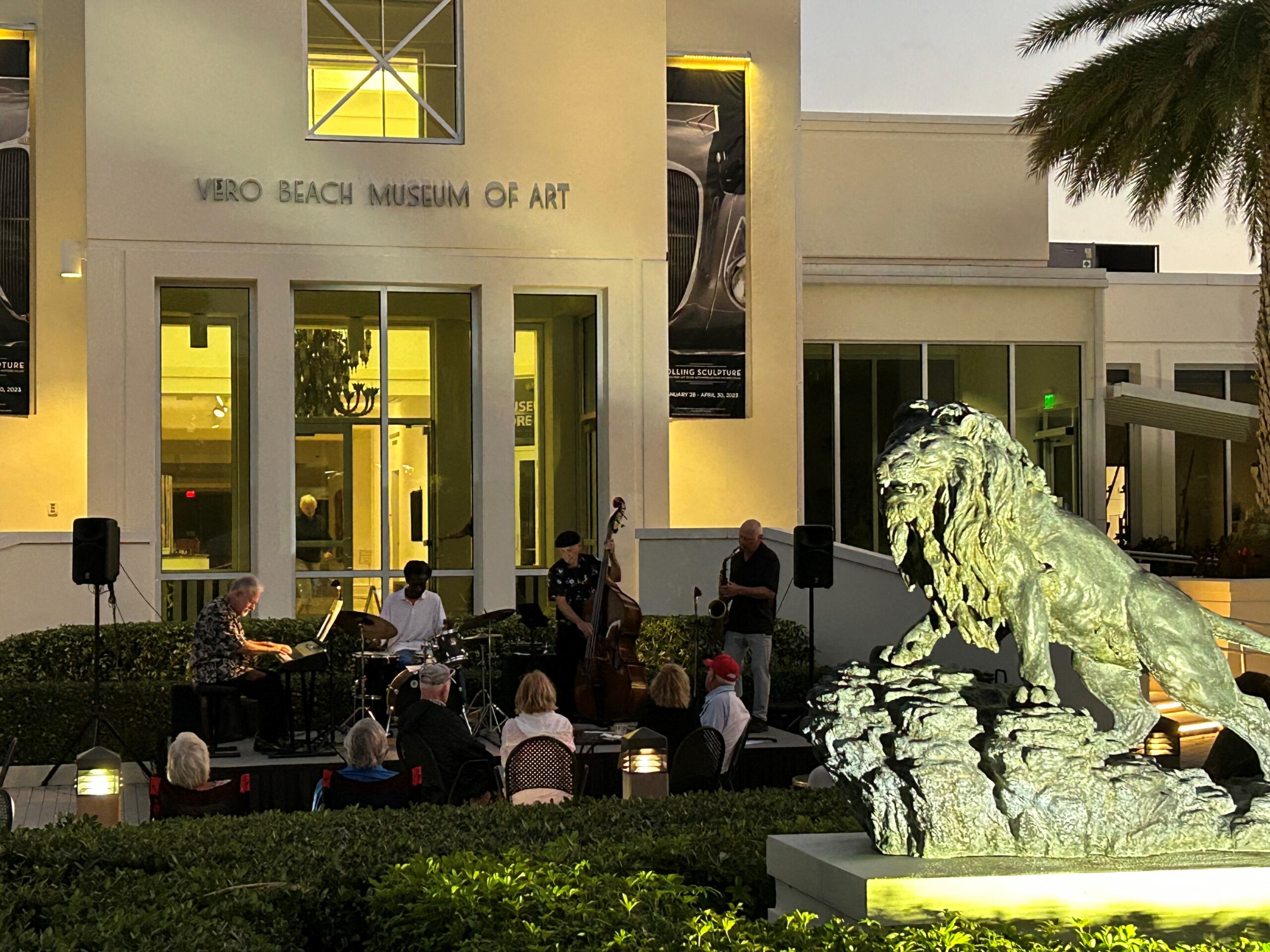 Band playing outside the VBMA in the evening at Concerts in the Park 2023.